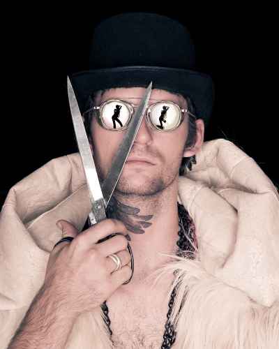 color photo of man with scissors