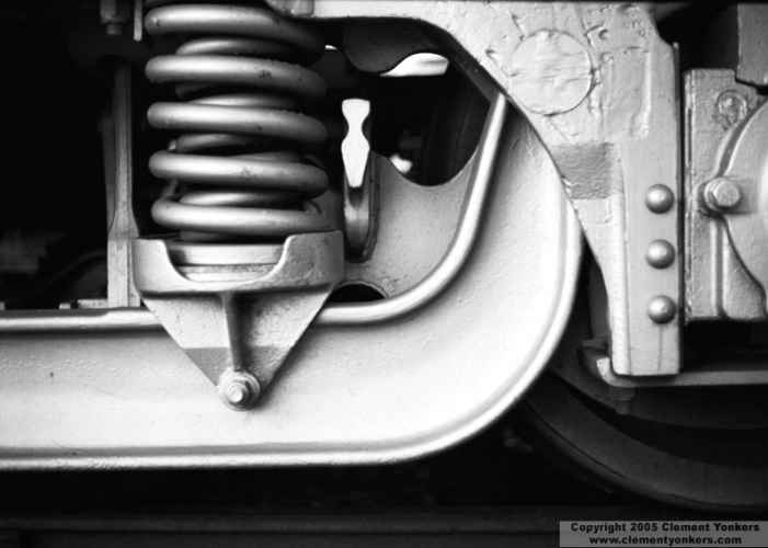 B&W photo of rail car trucks